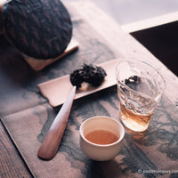 pu'er shengpu tea cake and brick from nannuo mountain, Yunnan, 2008 harvest vintage aged, brewed in glass pitcher with white ceramic cup