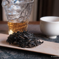 pu'er shengpu tea cake and brick from nannuo mountain, Yunnan, 2008 harvest vintage aged, brewed in glass pitcher with white ceramic cup