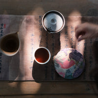 Detail of cake of pu'er shupu tea in pressed cake brick, fermented, from Yiwu mountain and ancient trees high quality tea