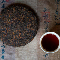 Detail of cake of pu'er shupu tea in pressed cake brick, fermented, from Yiwu mountain and ancient trees high quality tea