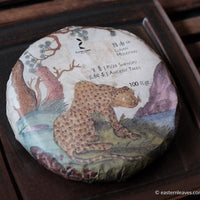 Pu'er shengpu ancient trees gushu in pressed cake, from Yunnan, China, with bamboo tray. 2021 spring harvest vintage