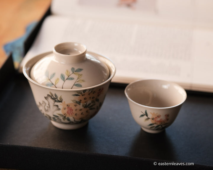 Gongfucha Chinese tea ceremony set with gaiwan and cup in Jingdezhen ceramic, a book, hand painted flowers pomegranate